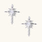 Silver starburst earrings with radiating points and dagger drop design featuring clear zirconia stones