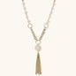 Long gold-plated necklace with freshwater pearls, chunky chain links, and flowing tassel pendant